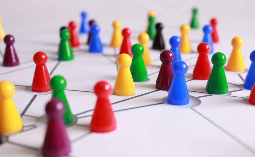 close up photography of yellow green red and brown plastic cones on white lined surface