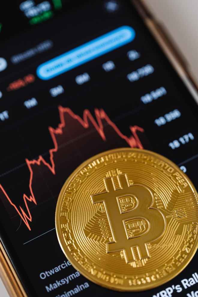 gold round coin on black laptop computer